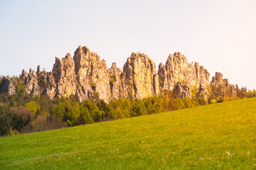 Monumental sandstone ridge of Suche Skaly, aka Dry Rocks, illuminated by summer evening sun near Mala Skala in Bohemian Paradise, Czech Republic