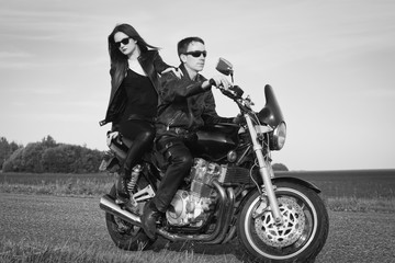 Active couple riding on the motorbike