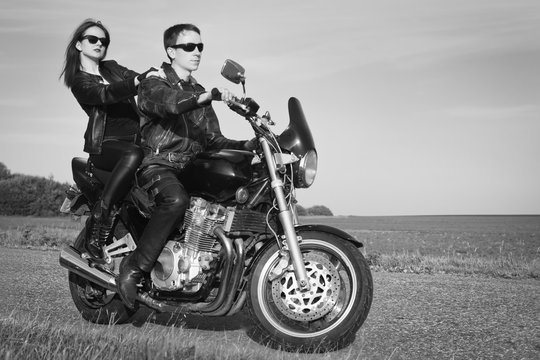 Active couple riding on the motorbike