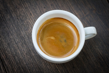 Espresso double shot on wood background vintage tone