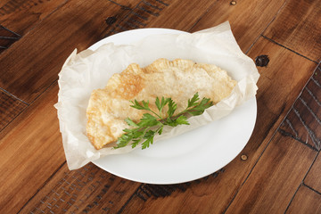 cheburek with meat on white plate. chiburekki - traditional asia kitchen. wooden background