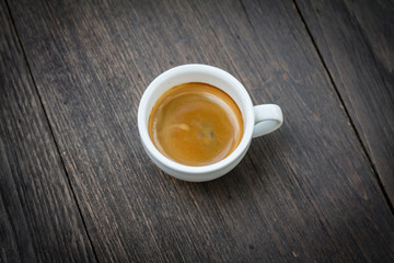 Espresso double shot on wood background vintage tone
