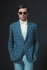 Sharp dressed young man in retro 1920s style. Wearing sunglasses