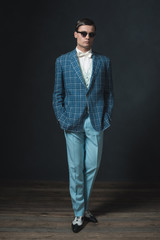 Sharp dressed young man in retro 1920s style. Wearing sunglasses