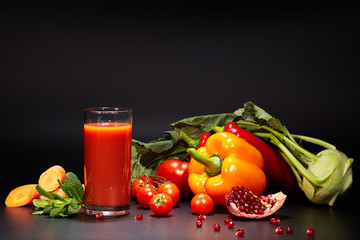 Tomato juice in a glass jar on a black table