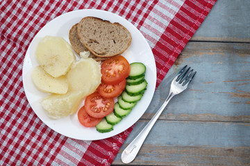 Boiled potatoes with fresh vegetable. Healthy or cooking concept