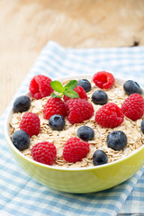 Oatmeal porridge with berries. Raspberries and blueberries.