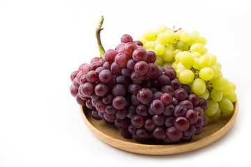 Grapes in wooden dish white background 