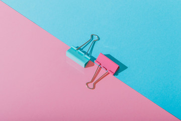 geometry minimal set with two paper clips in the middle on blue and pink backgrounds