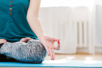 Girl sitting in lotus position and hands gesturing zen