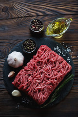 Above view of raw fresh beef minced meat with seasonings