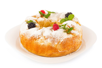 Sweet pie with fresh berry and leaf of mint on ceramic plate