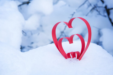 Heart in a snow-covered snowdrift. Concept of Christmas and Valentine's Day