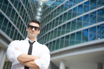 Obraz premium Portrait of a handsome businessman standing outdoors near office building