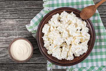 cottage cheese on clay dish with wooden spoon