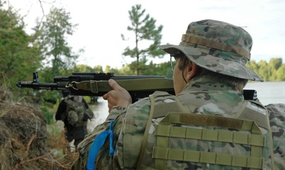A soldier with a gun aiming at the enemy