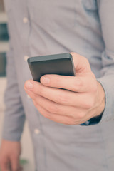 Urban guy / businessman with a cellphone. Shallow depth of field.
