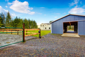 Farm blue barn shed and gravel driveway.