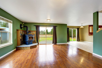 Open floor plan interior with green walls and hardwood floor.