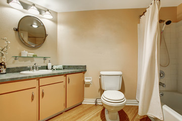 Lovely bathroom interior with vanity cabinet and granite counter top.