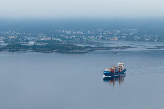 Unknown destination / Industrial ship going to the sea in a foggy day. Ålesund, Norway.