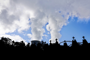 cemetery crosses and smoke with blue sky,concept death for pollution  and contamination