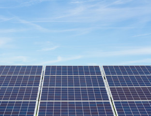 A solar panel generating electricity under a blue sky for copy space.
