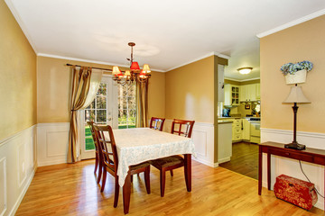 Dining area with table set and nice curtains.