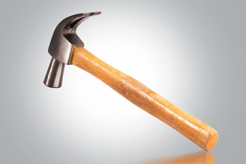 claw hammer with wooden handle on gray background