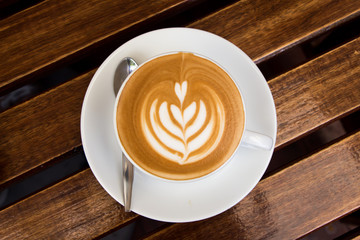 Latte cup on wooden table 