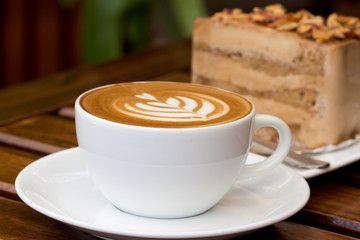 Latte cup on wooden table 