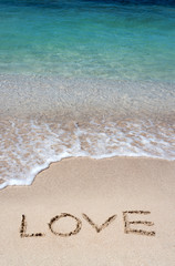 Romantic beach getaway with the word Love
