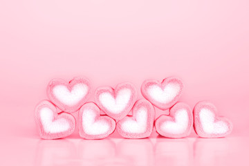 the marshmallow heart shape on pink background with love concept