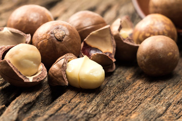 Close up macadamia nuts on wooden plate