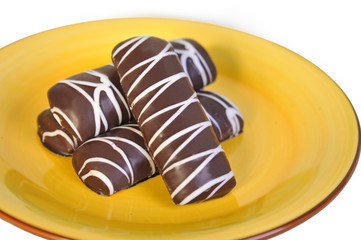 Chocolate chip cookies, lying on a yellow plate. Closeup.