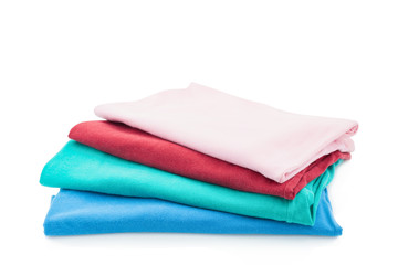 Pile of colorful clothes isolated on white background.