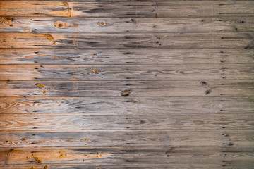 Wooden boards burned by sun from one side
