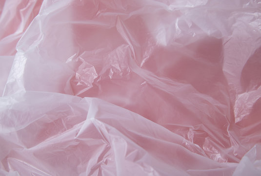 A full page of white polythene plastic bag texture on a red background