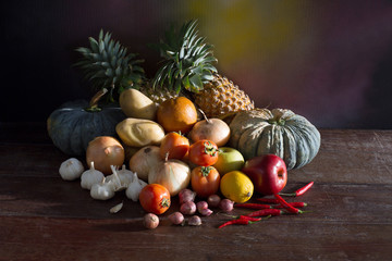 Pile of fresh fruits and vegetable on the old wooden table