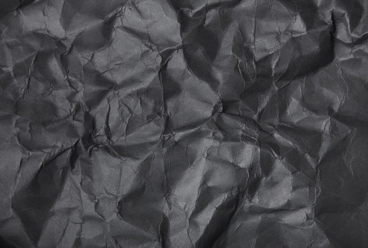 A full page of screwed up black craft paper texture