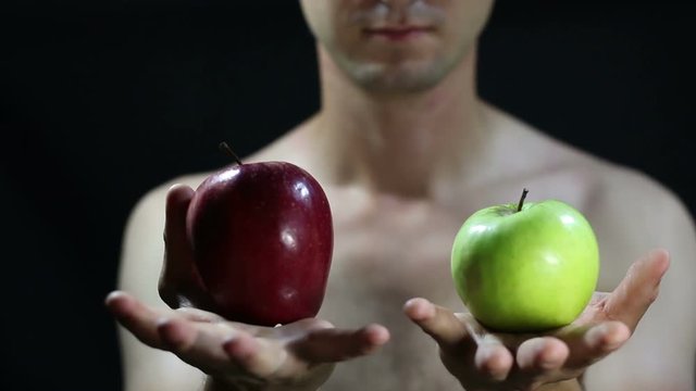Male hand offering an apples to choose
