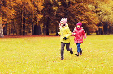 group of happy little girls running outdoors