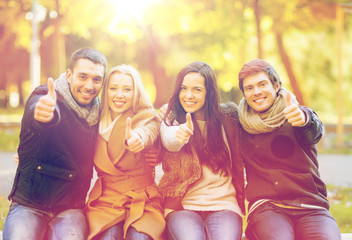 group of friends having fun in autumn park