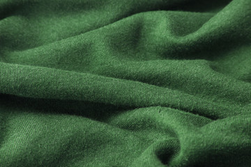 A full page of ripples of fuzzy green fleece fabric texture