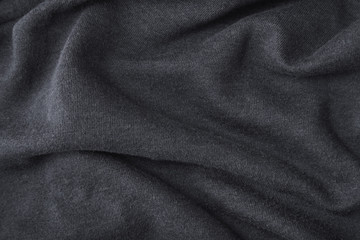 Fototapeta na wymiar A full page of ripples of dark grey fleece fabric texture