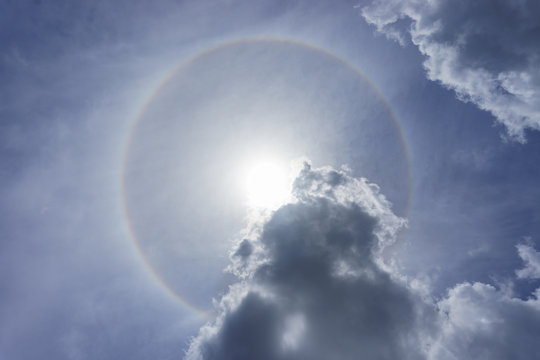 Sun and halo ring and cloud on Blue sky in sunny day.