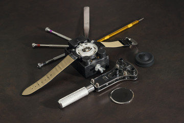watch and watchmaker tools prepare to repair it