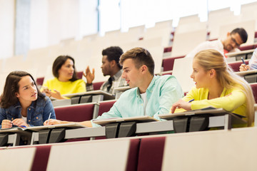 group of students with notebooks in lecture hall