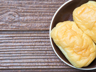 Two delicious butter bread bun on the  brown plate for healthy breakfast for everyone in family, or can be great baked bun for coffee break during meeting