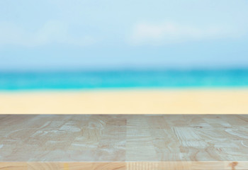 Wood table on beach sea summer day background and water blue sand blurred